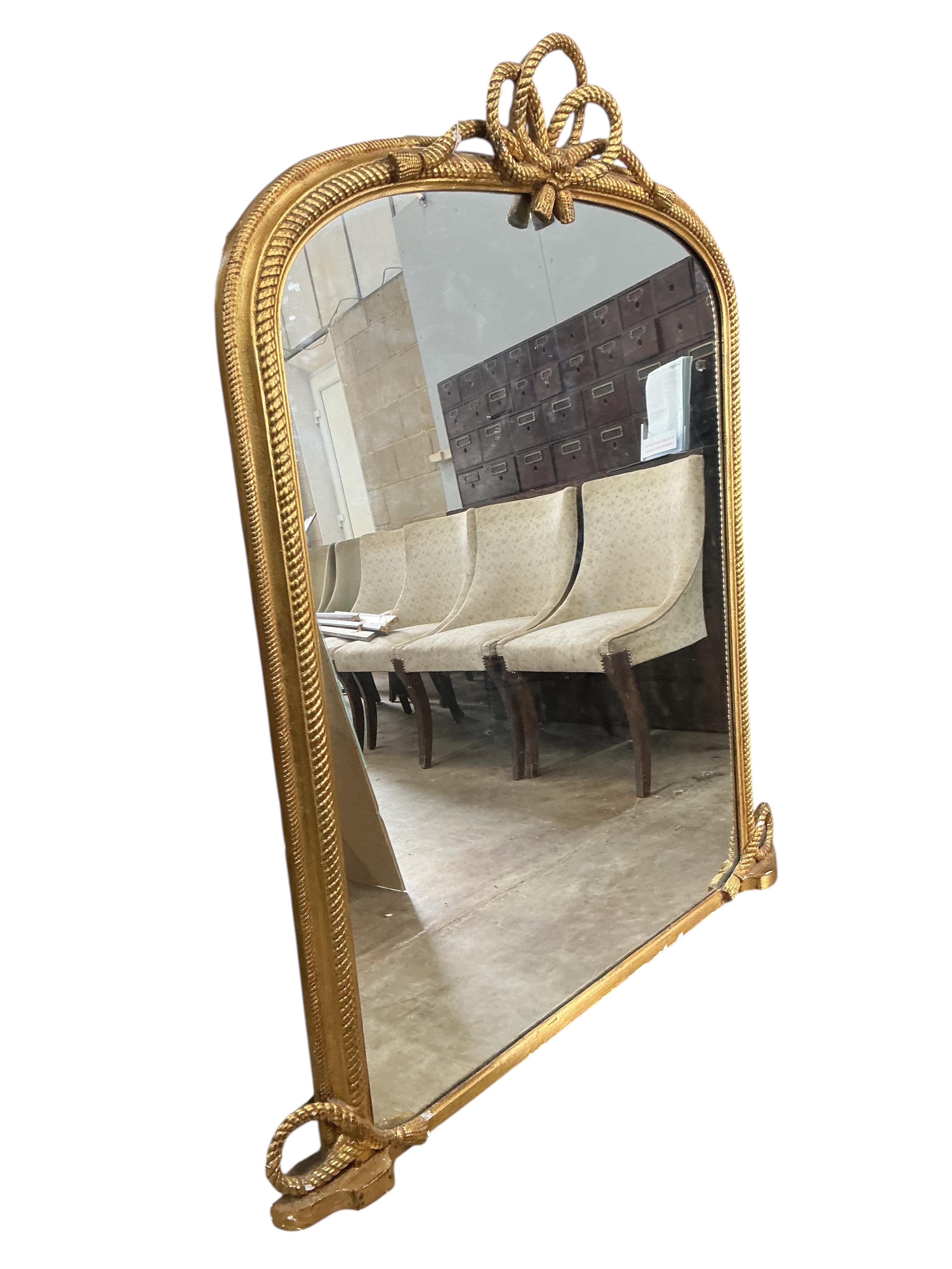 A Victorian giltwood and composition overmantel mirror with tied rope twist pediment, width 124cm, height 144cm